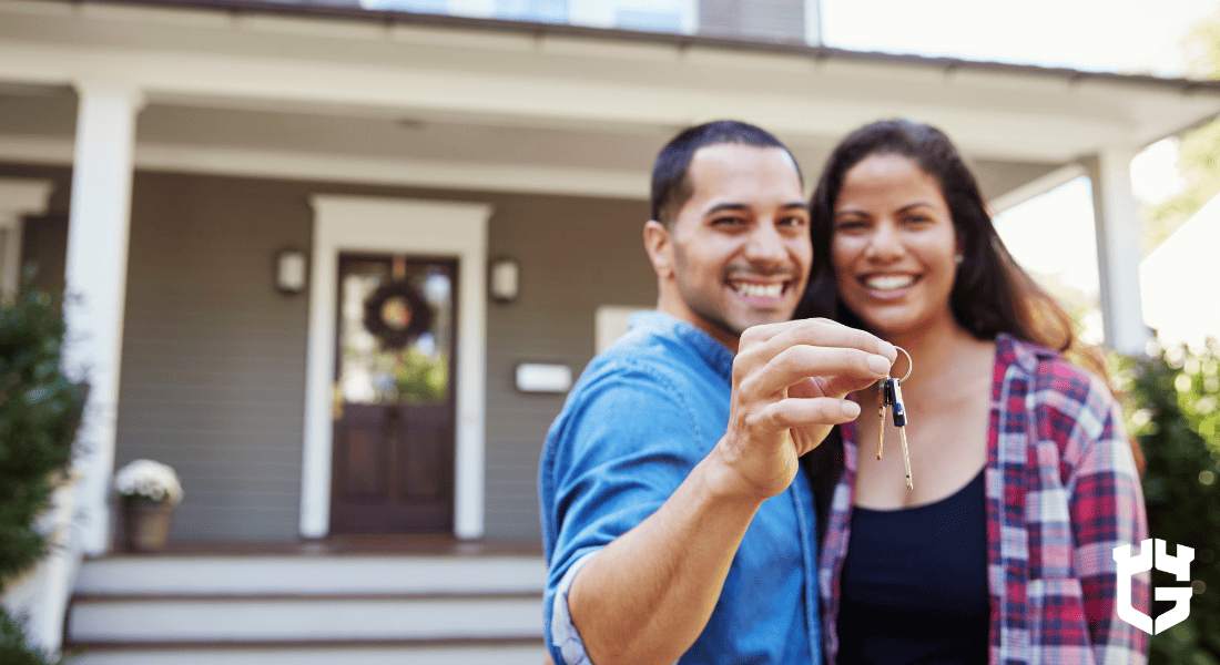 A couple in front of their home.