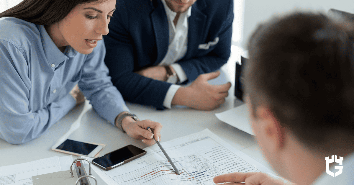 Agent reviewing insurance documents with clients, discussing carrier financial strength and claims payout reliability